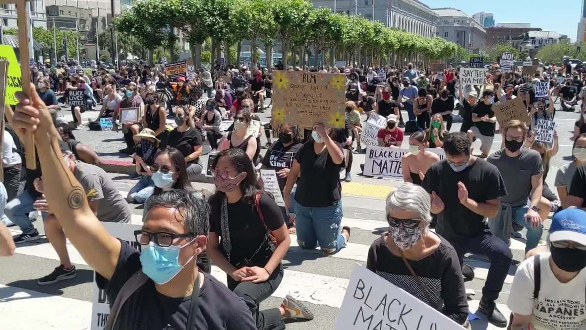 USA: Protesters outside San Francisco’s City Hall take a knee in tribute to George Floyd
