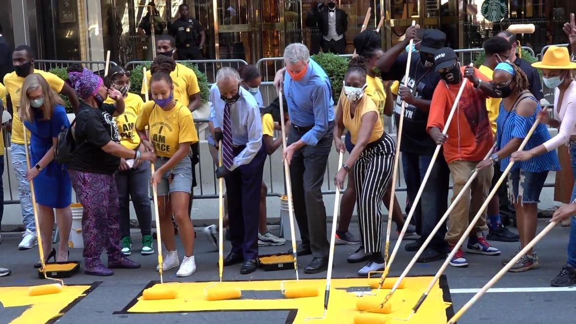 USA: NYC Mayor Bill de Blasio paints 'Black Lives Matter' street mural in front of Trump Tower