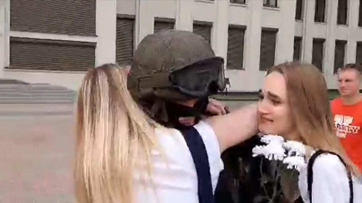 Belarus: Protesters hug members of security forces lowering shields