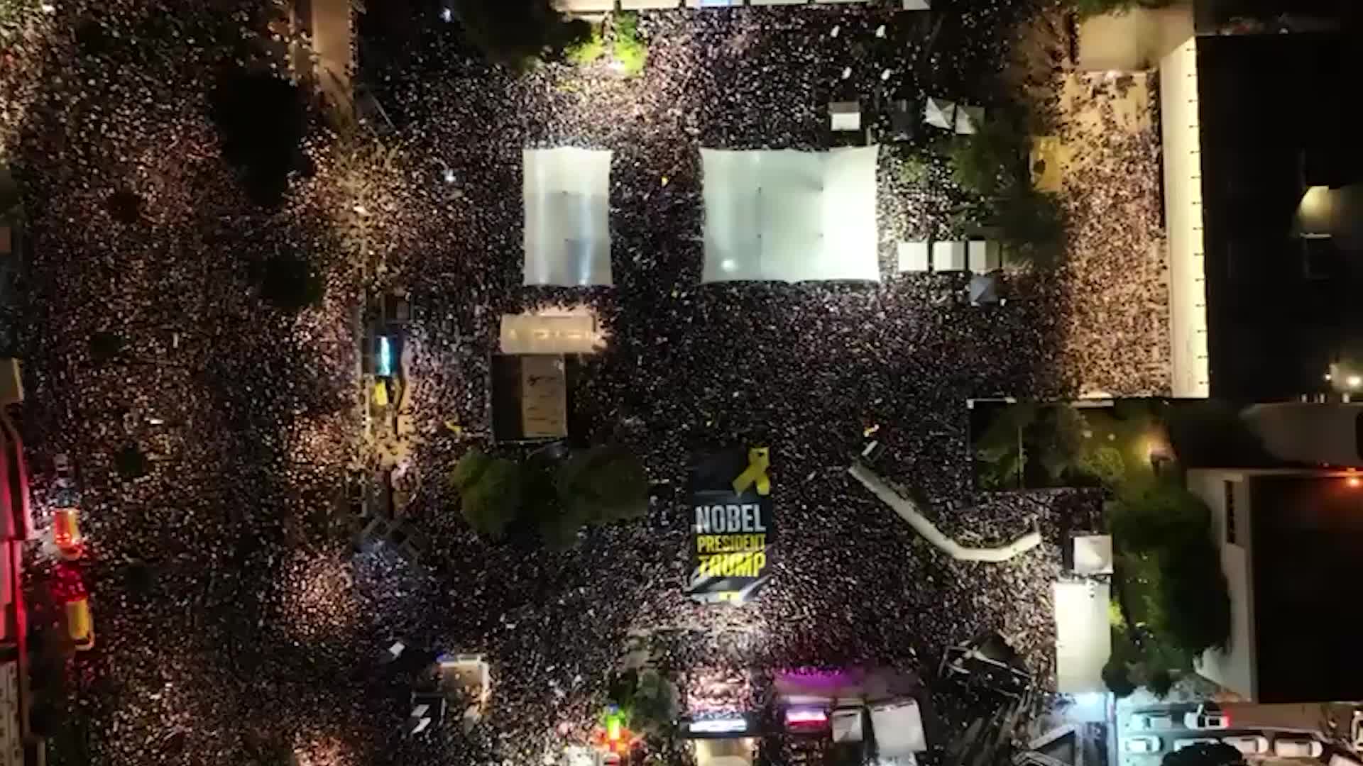 'Nobel President Trump' - Huge banner unfurled at Hostages Square rally