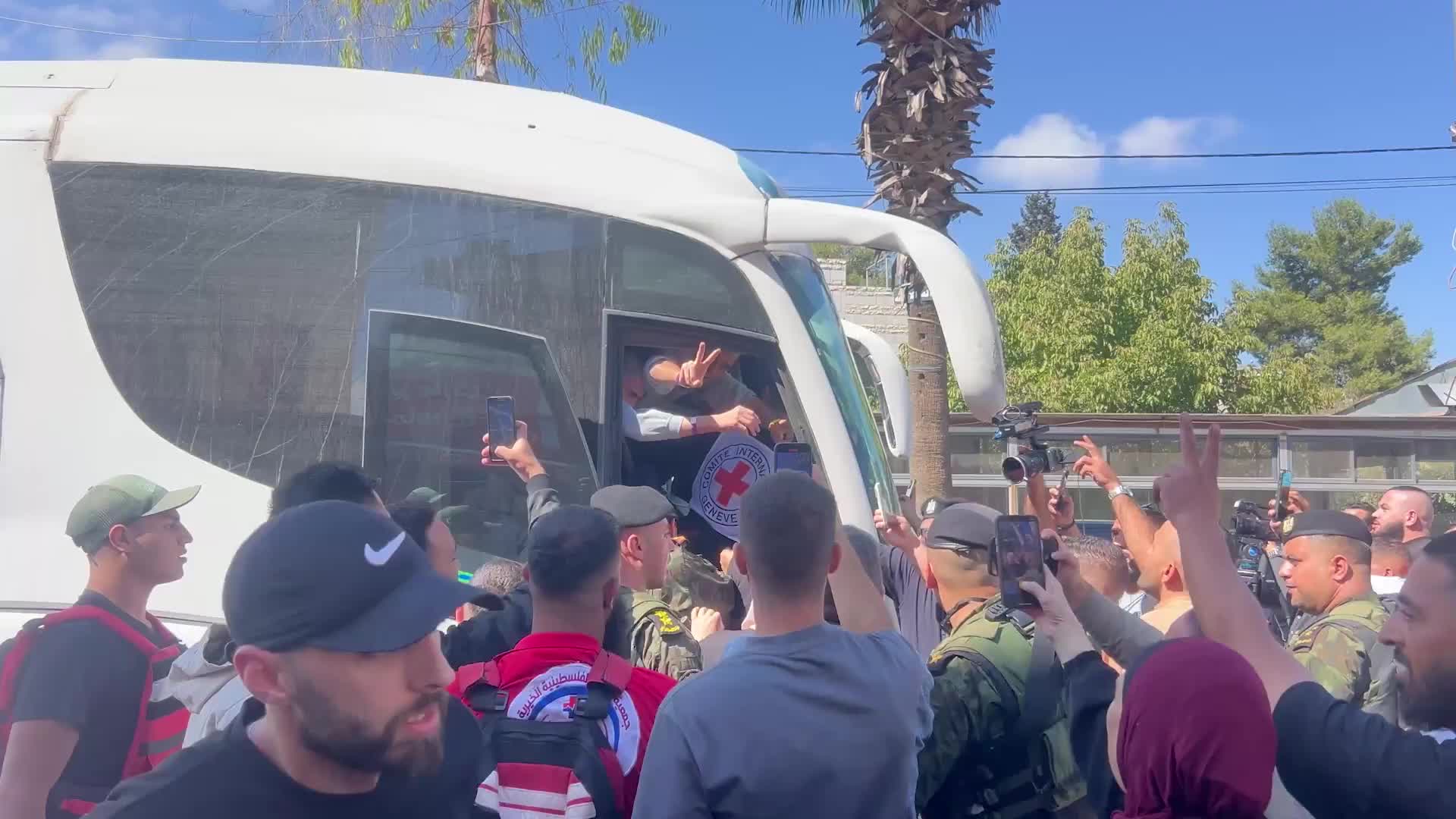 En route to Ramallah - Red Cross buses transport Palestinian prisoners through Beitunia as truce takes effect